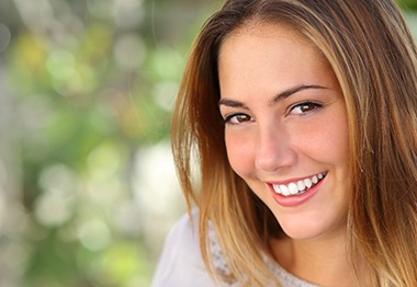 Woman with dental implants in Hoboken smiling outside