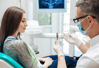 a patient learning about the dental implant procedure 