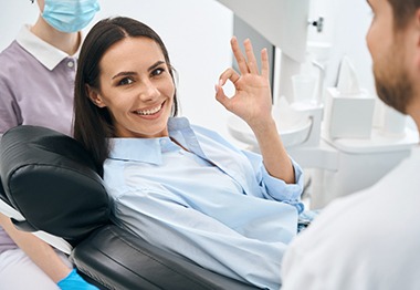 A smiling woman who just received tooth-colored fillings