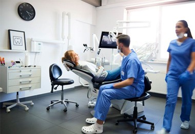 Dentist and patient engaged in conversation
