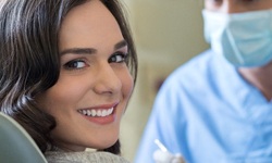 Woman smiling with cosmetic dentist in Hoboken