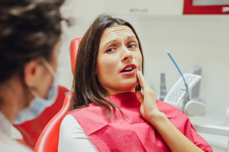 Woman talking to dentist during dental checkup