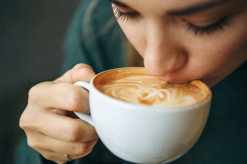 closeup of young woman drinking coffee