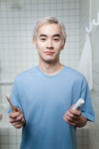 Man holding toothbrush and toothpaste
