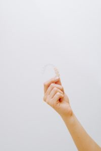 Woman’s hand holding Invisalign